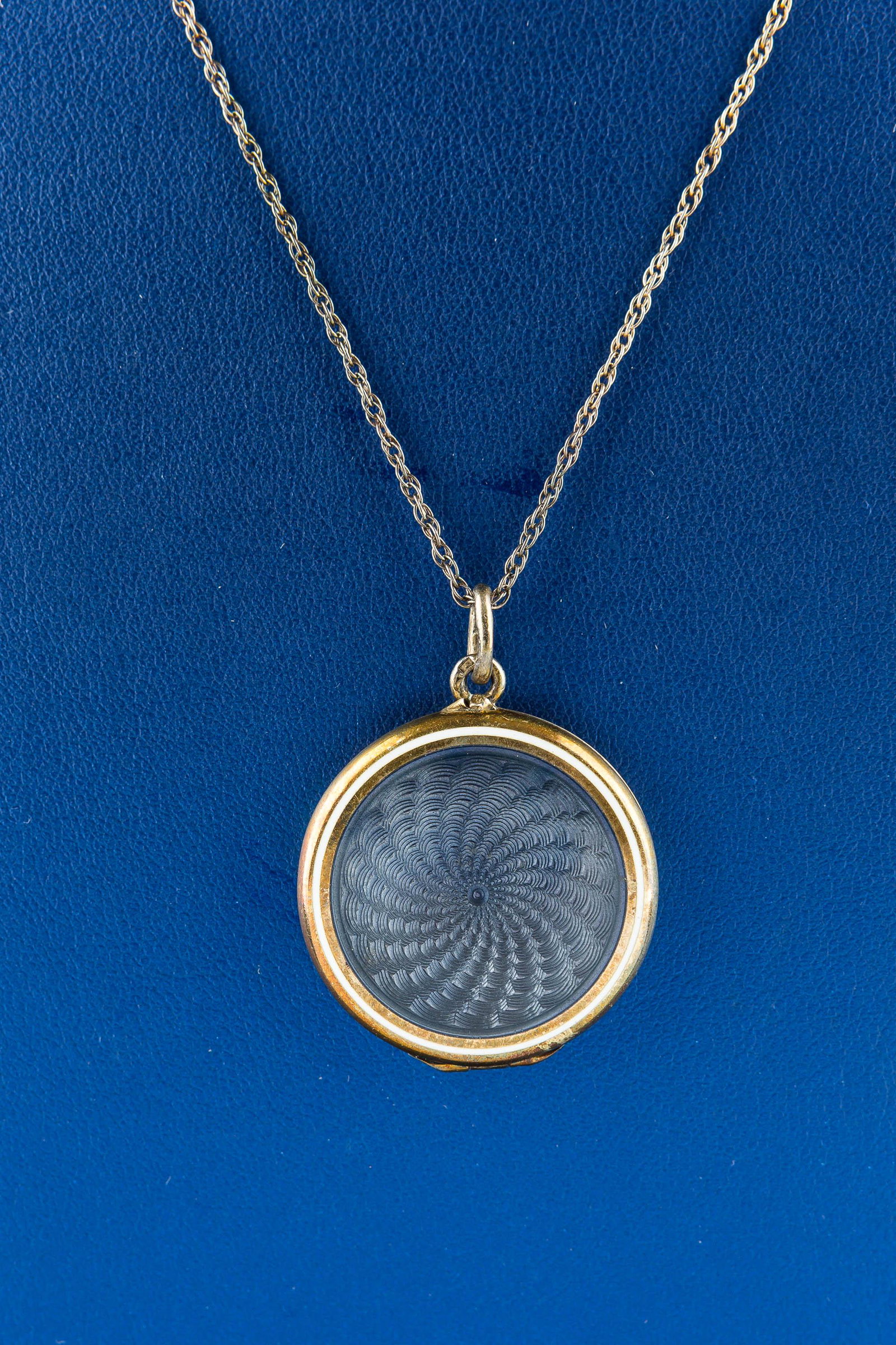 Sterling Silver Enamel Vintage Necklace: This beautifully guilloche enameled locket with a blue swirled pattern hangs on a sterling silver chain and features a two-photograph interior.