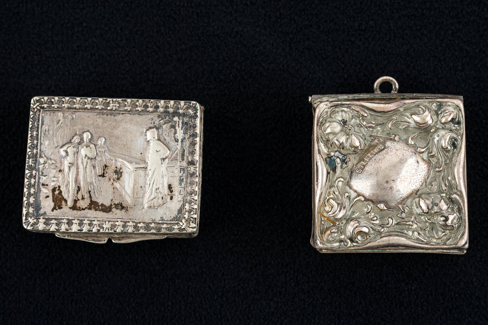 Antique Silver Pillboxes: The first of these boxes is marked ".800 Italy" and features and Italian street scene with decorative floral detailed body, measuring approx. 1 3/8" across. The second is a sterling silver square Chat