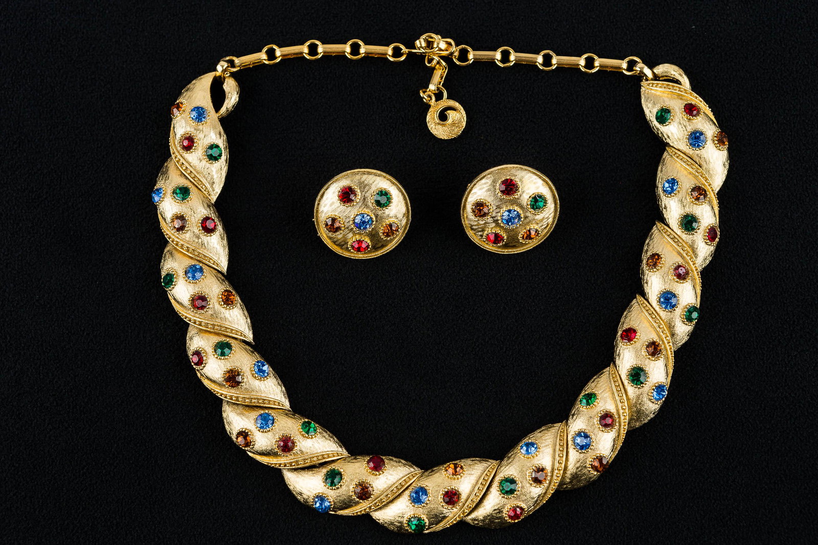 Lisner Vintage Necklace & Earring Set: This gold tone necklace with blue, green, red, and amber colored rhinestones is signed "Lisner" and measures approx. 18.5"L. It is accompanied by a matching pair of round screw back earrings, and all 