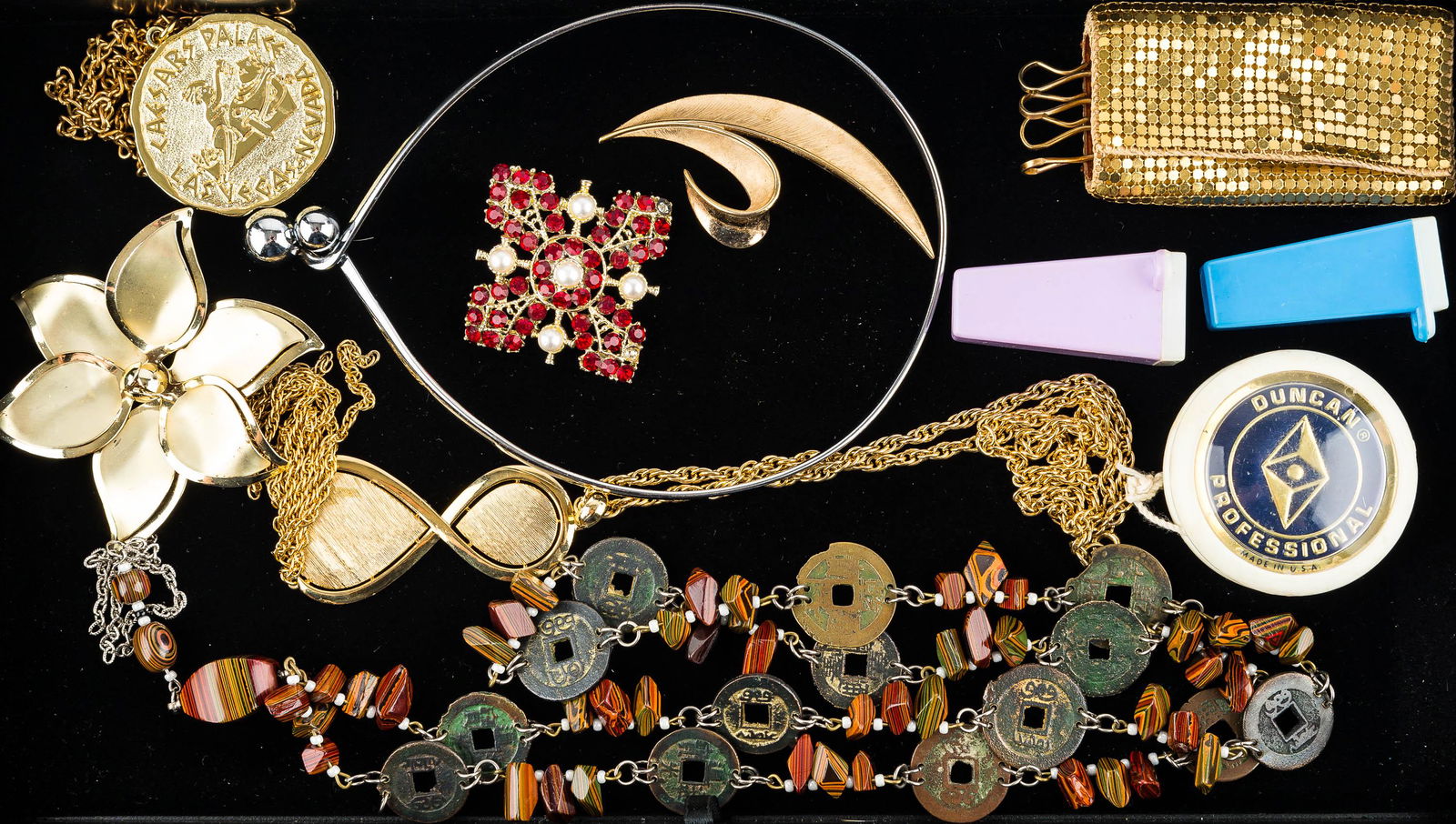 Trifari & Mixed Costume Jewelry Collection: The highlight of this eclectic collection is a gold tone leaf brooch signed Trifari measuring approx. 3.25"L, a vintage mesh keychain, a red rhinestone and faux pearl brooch, an Asian coin necklace, a