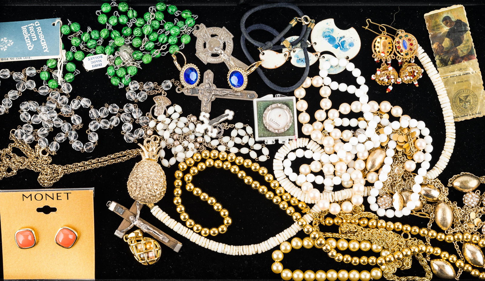 Religious & Other Jewelry Grouping: This grouping has a rosary marked "Italy" and a second marked "Irish Made", a pair of Monet post earrings on hang card, a pineapple watch signed "Taylorette", and other necklaces, earrings, and more.