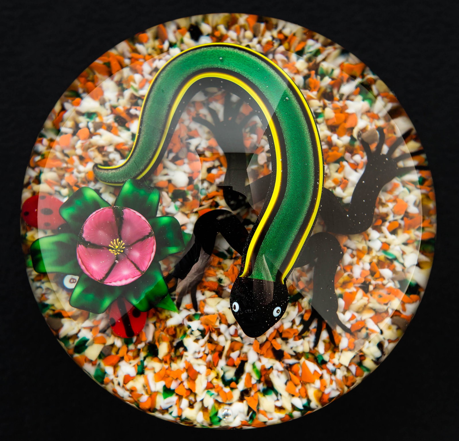 Bob Banford (Amer, b.1951) Salamander Paperweight: This signed lampwork art glass paperweight contains a mutlicolored salamander with a flower and two ladybugs. It has a "B" initial on interior and measures approx. 3.25" diameter. It has no visible fl