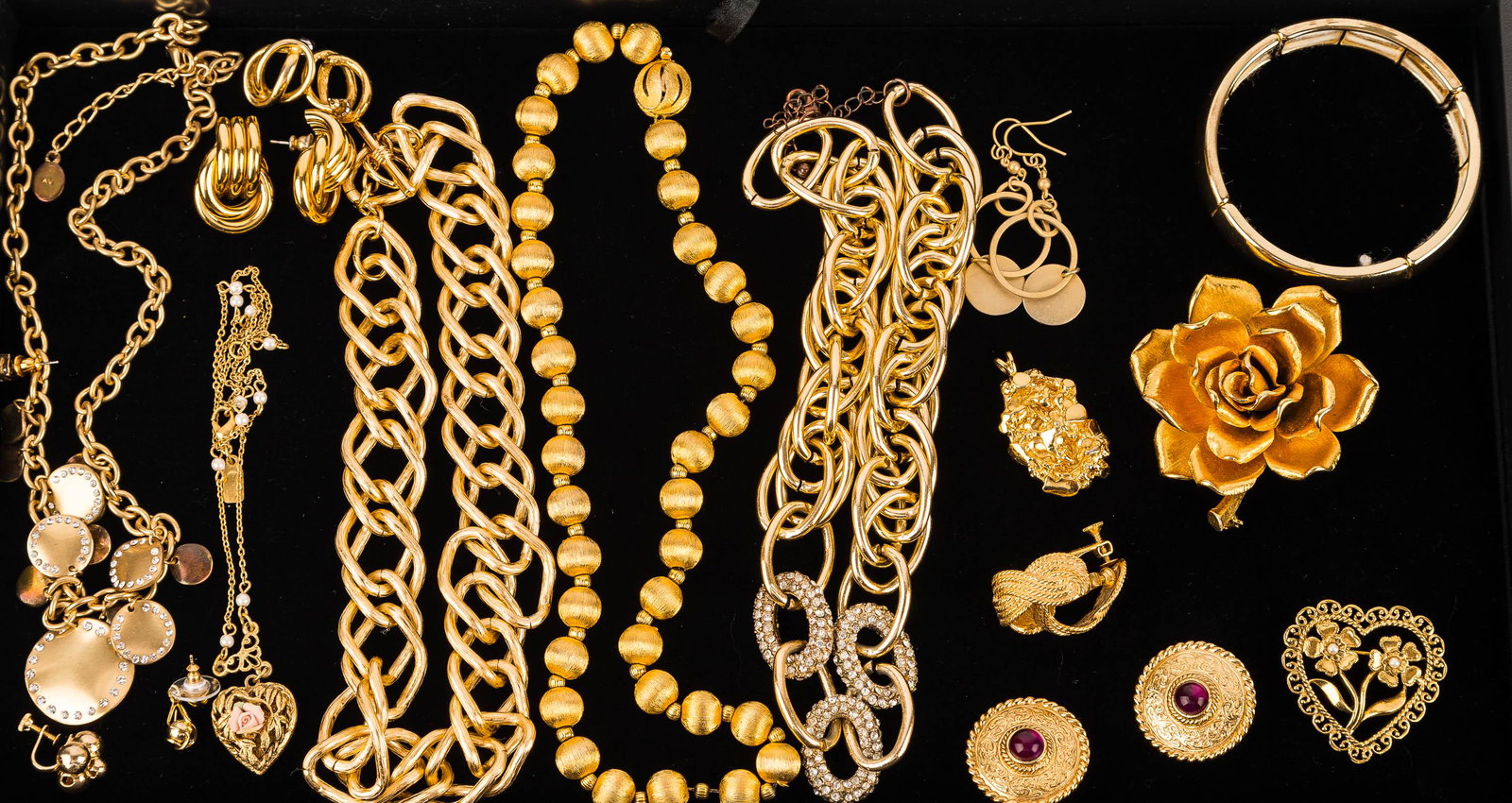 Mixed Jewelry Group: 14 items featuring a Givenchy (Paris-New York) clip earrings with purple cabochons, Kramer flower brooch, an Adrienne Vittadini necklace and more.