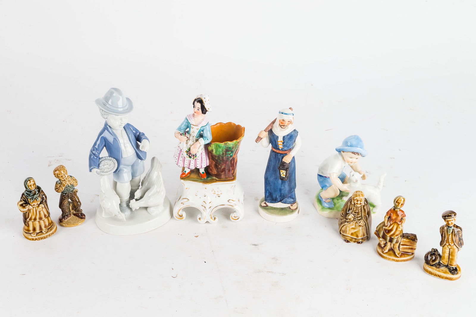 Bavarian, English, Irish, and German Figurines: Including 5 wade figurines, a royal Worchester figure of a boy. Gerard Porzellan figure of a boy with chickens, 20th century Staffordshire spill vase, Goebel west German figure of a shepherd. Largest