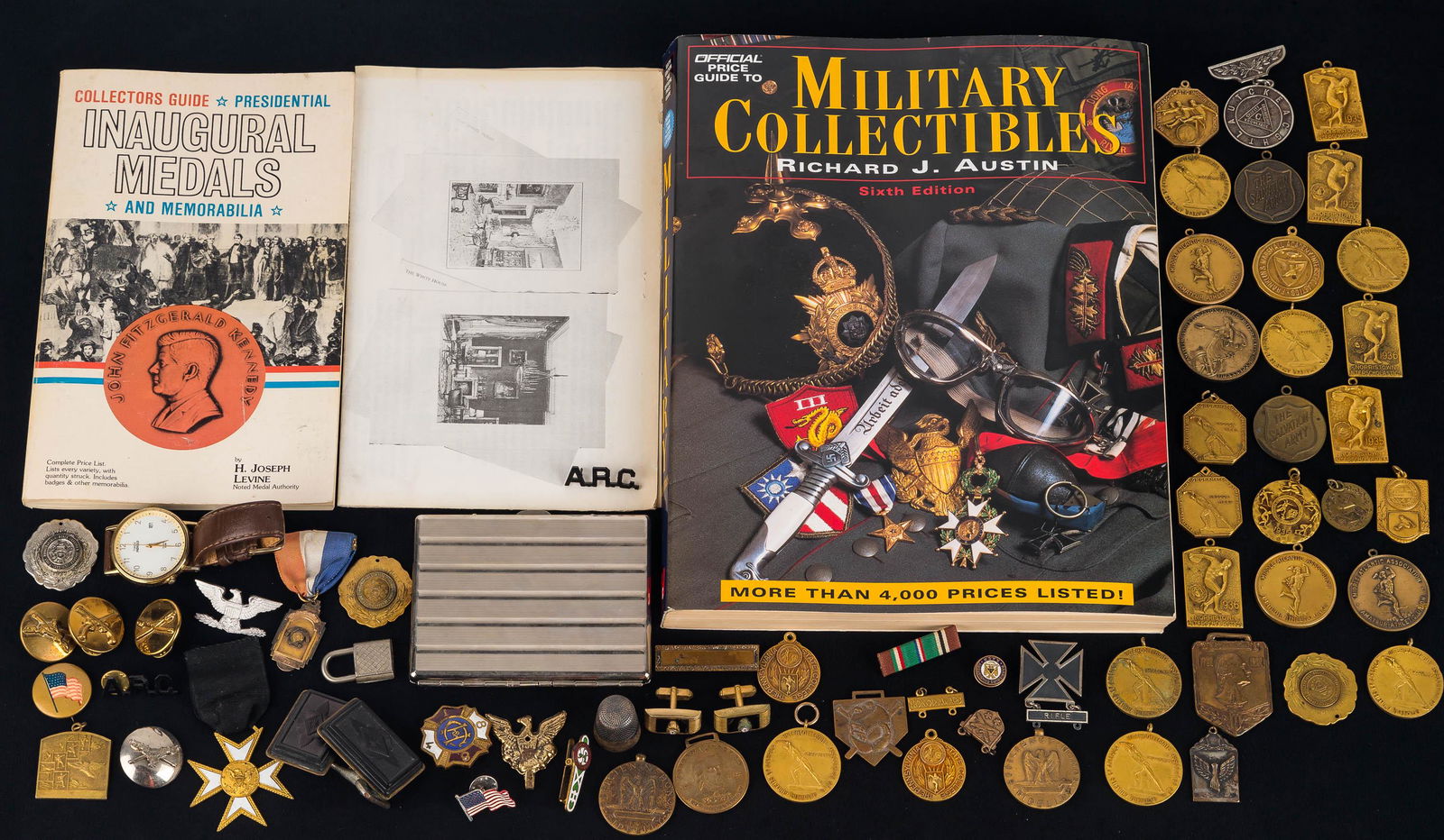Military Insignias and Vintage Sports Medals: Various military insignias, sterling silver thimble, some sterling pins, belt buckles, cigarette case (not silver), and over 20 sports medals from the 1930s. Also includes a Collectors Guide to Presid