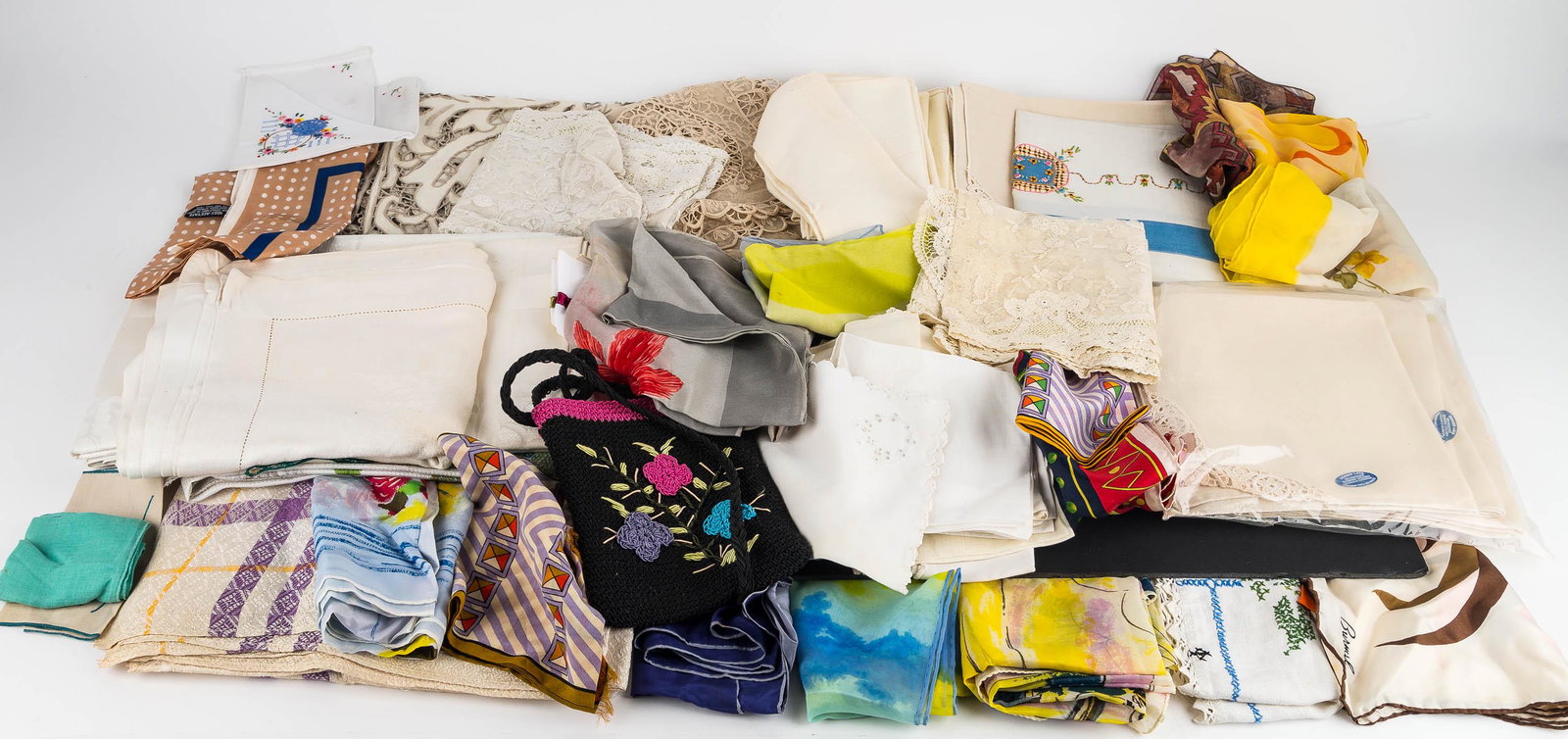 Handkerchiefs, Scarves, & Table Linens: There are embroidered and printed hankies, a selection of printed scarves, and table napkins.