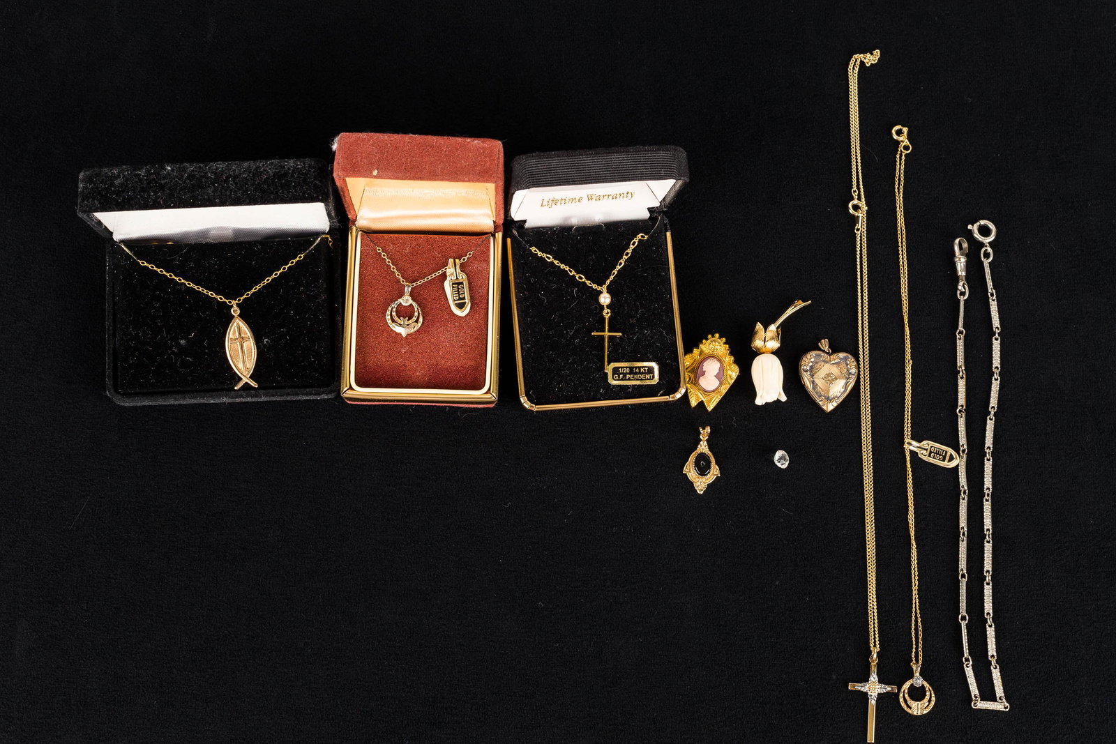 Gold-Fill Religious & Other Jewelry: This gold-fill lot features crosses on chains, a gold-fill dove on chain, a small gold-fill cameo, a gold-fill heart locket, and other gold-fill jewelry.