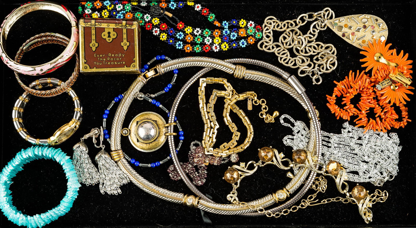 Mixed Costume Jewelry: Jewelry includes a gold tone necklace with tan rhinestones a choker with pendant marked "Rico's" a silver tone and gold tone choker, a gold tone Monet necklace measuring approx. 17.5"L, and other cost