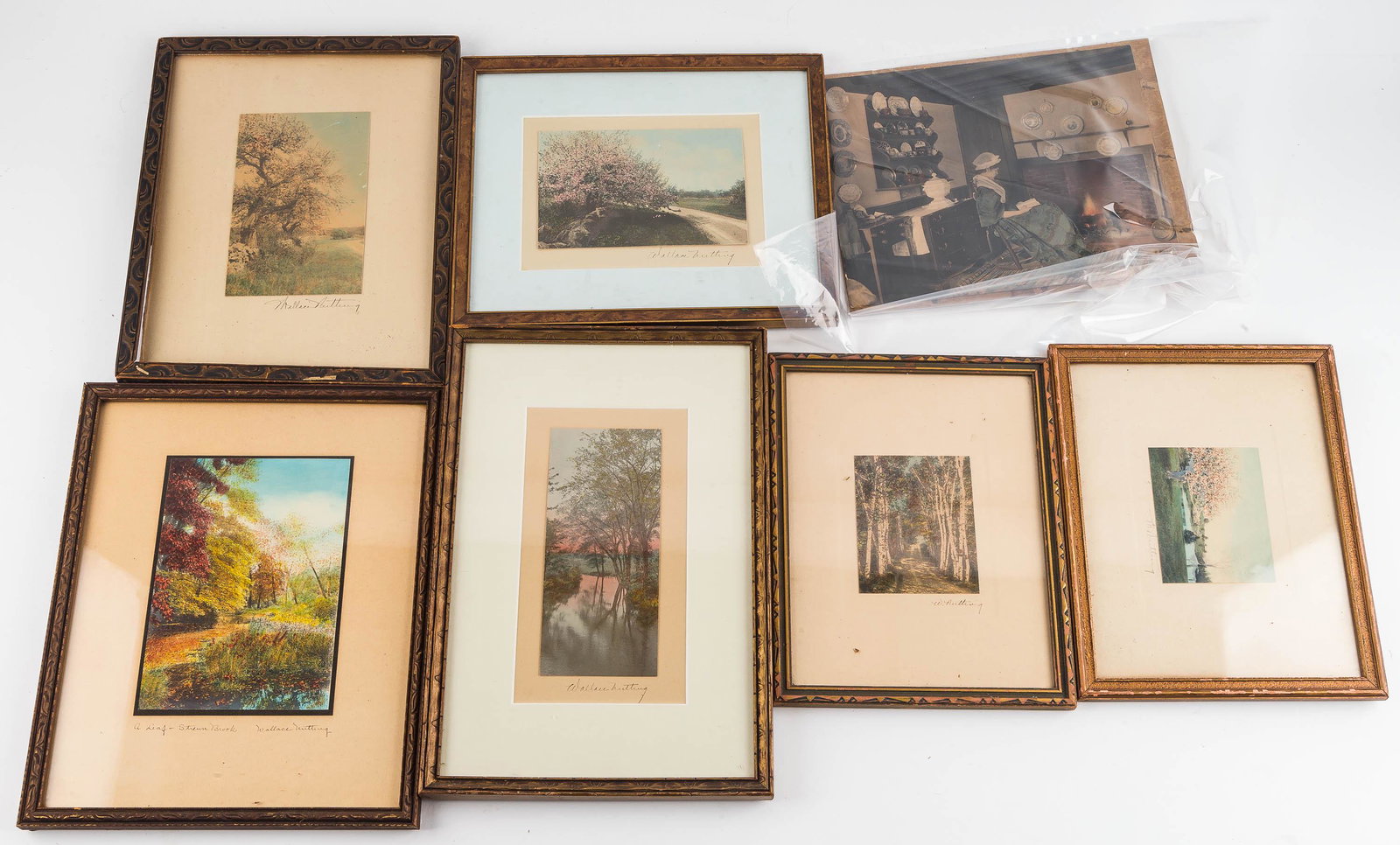 Wallace Nutting Hand Colored Photographs (7): Six are framed landscapes signed in the matting; one is titled "A Leaf - Stream Brook" . The largest is the unframed interior scene, 7.5" x 9.5" (dog eared bottom right corner/tear approx 1.25")