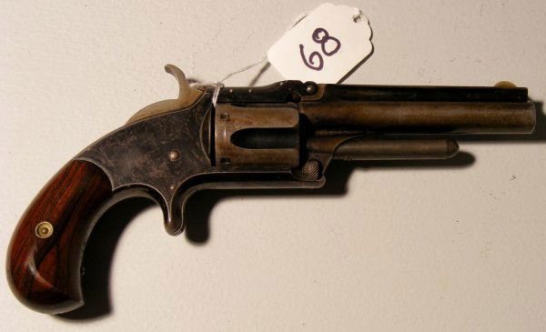 Smith and Wesson Model 1-1/2 Second Issue Revolver: Smith and Wesson Model 1-1/2 Second Issue Revolver Standard Issue; company name and address marked on barrel. The revolver has the patent dates of 1855, 1859 and 1865 as well as rosewood grips. The re