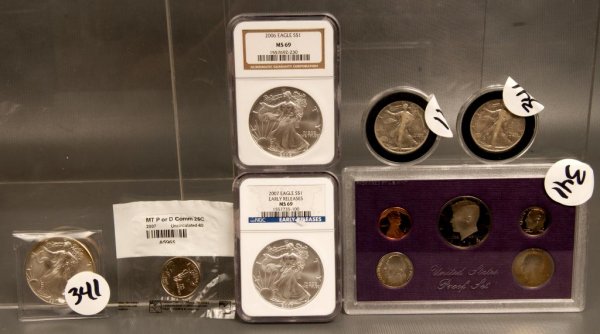 Coins - Silver dollars: Three one dollar silver eagles, two walking liberty half dollars; 1991, 2006,2007 eagle silver dollars; 1942, 1943 walking liberty half dollars; 1984 proof set; one uncirculated Montana Quarter