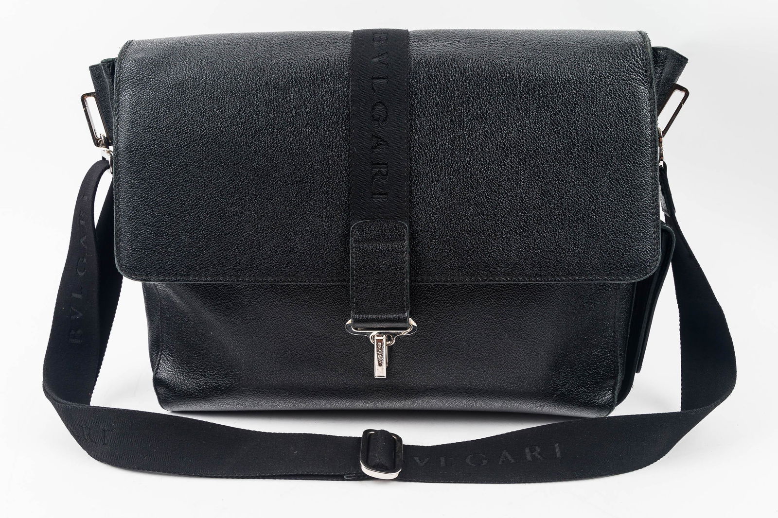 BVLGARI Designer Messenger Bag: BVLGARI Made in Italy black leather messenger bag with BVLGARI embossed into strap and silver tone closure and hardware.