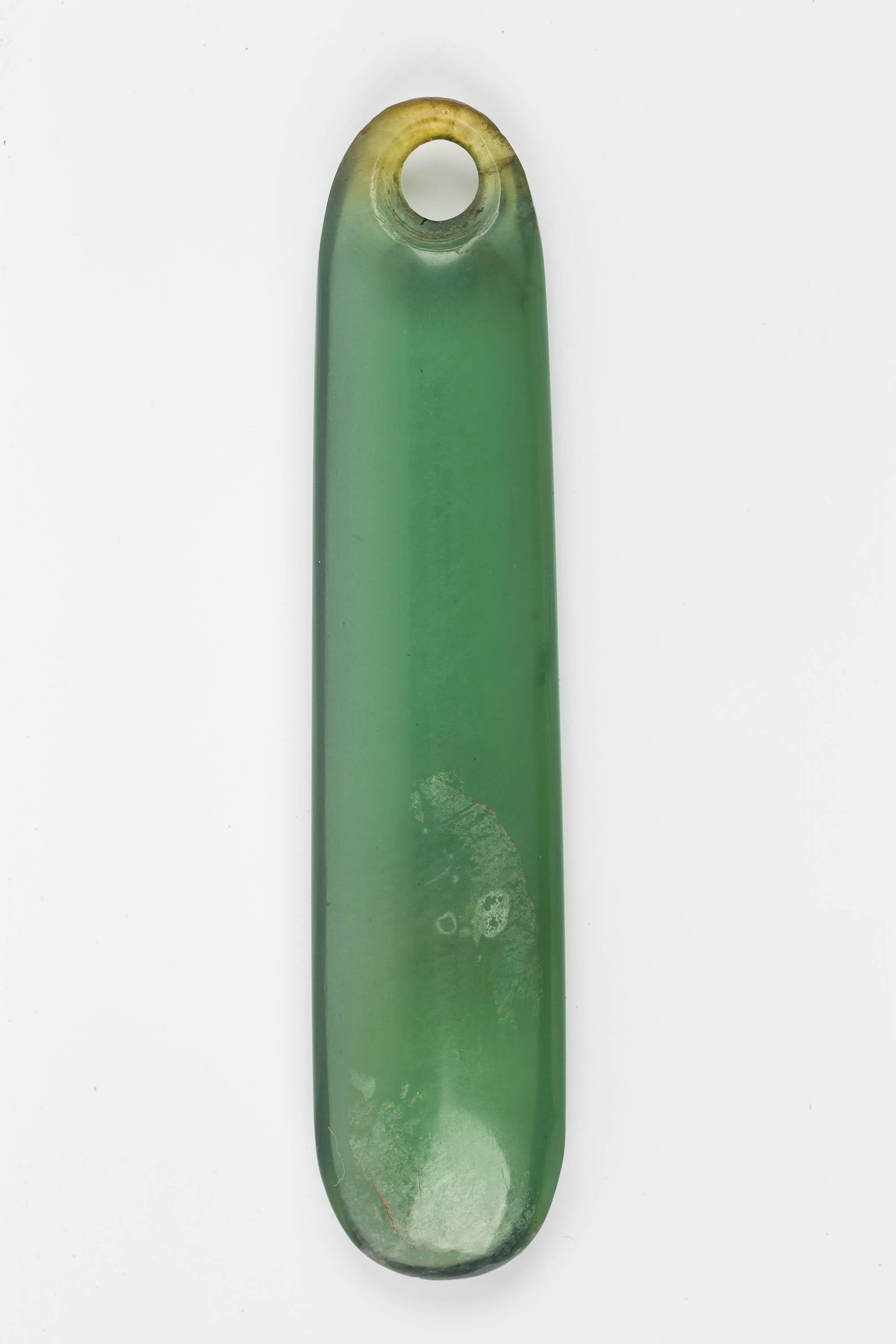 Maori Tribal Kuru Drop Jade Pendant: This approx 2.5" Nepherite clear to green jade pendant is a Maori tribal pendant. The hole is bi-conically drilled. It has natural stone inclusions (near the hole that looks a crack but is not) and is