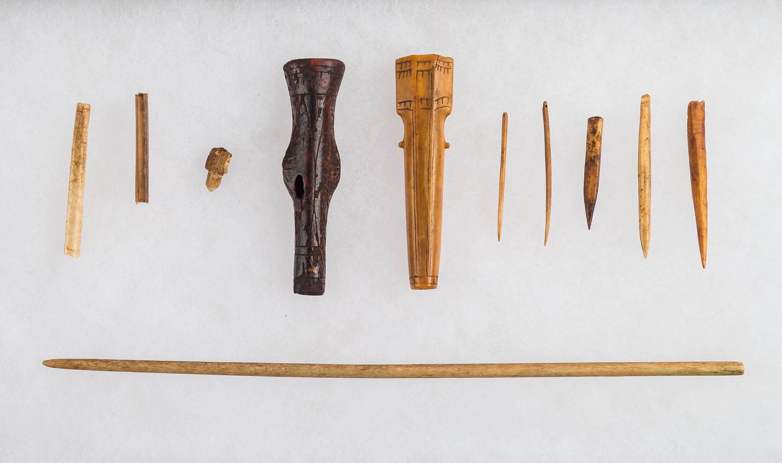 Inuit Sewing Accessories (10 Items): There are two carved and decorated needle cases (mineralized) largest approx 3", bone needles and awls (largest approx 9") from the Inuit from Old Bering Sea / Bering Strait, Alaska area.