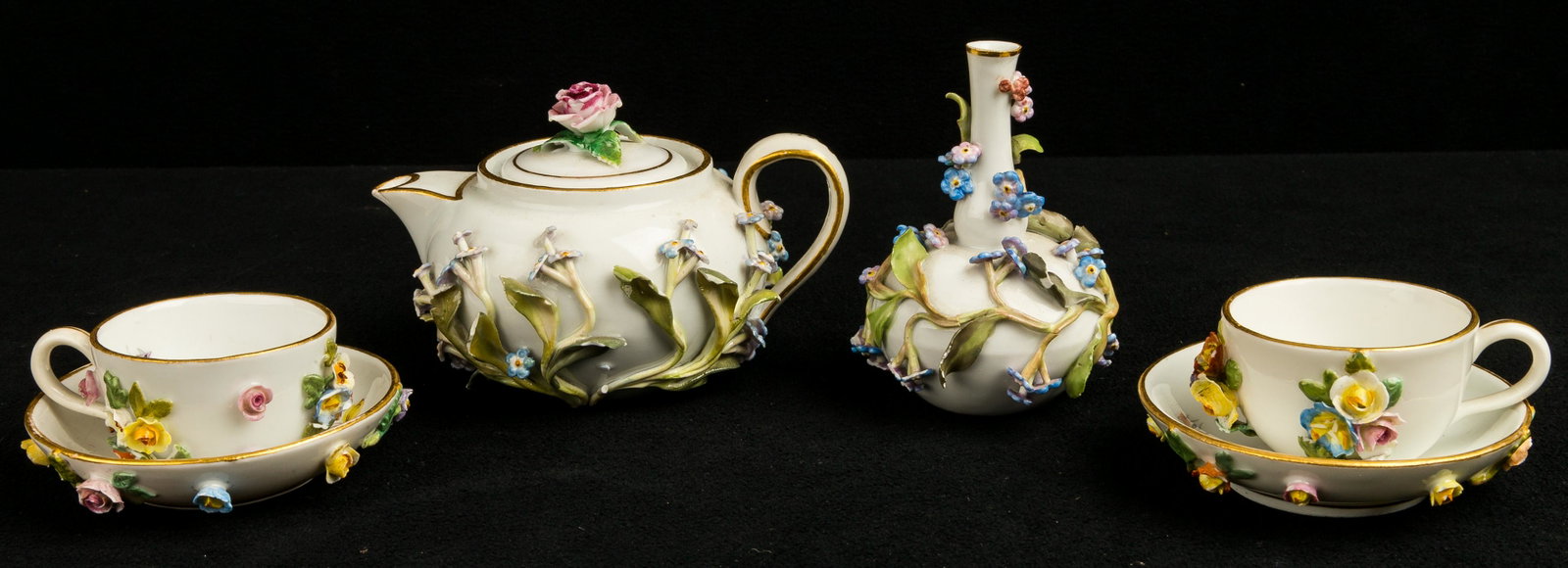 Meissen Forget Me Not Tea Set (6 pieces): This six (6) piece Meissen Forget-Me-Not miniature tea set is white porcelain with a floral design. Meissen marked on bottom of all pieces. 239 written on the bottom of the vase. Tea pot approx 2.25"H