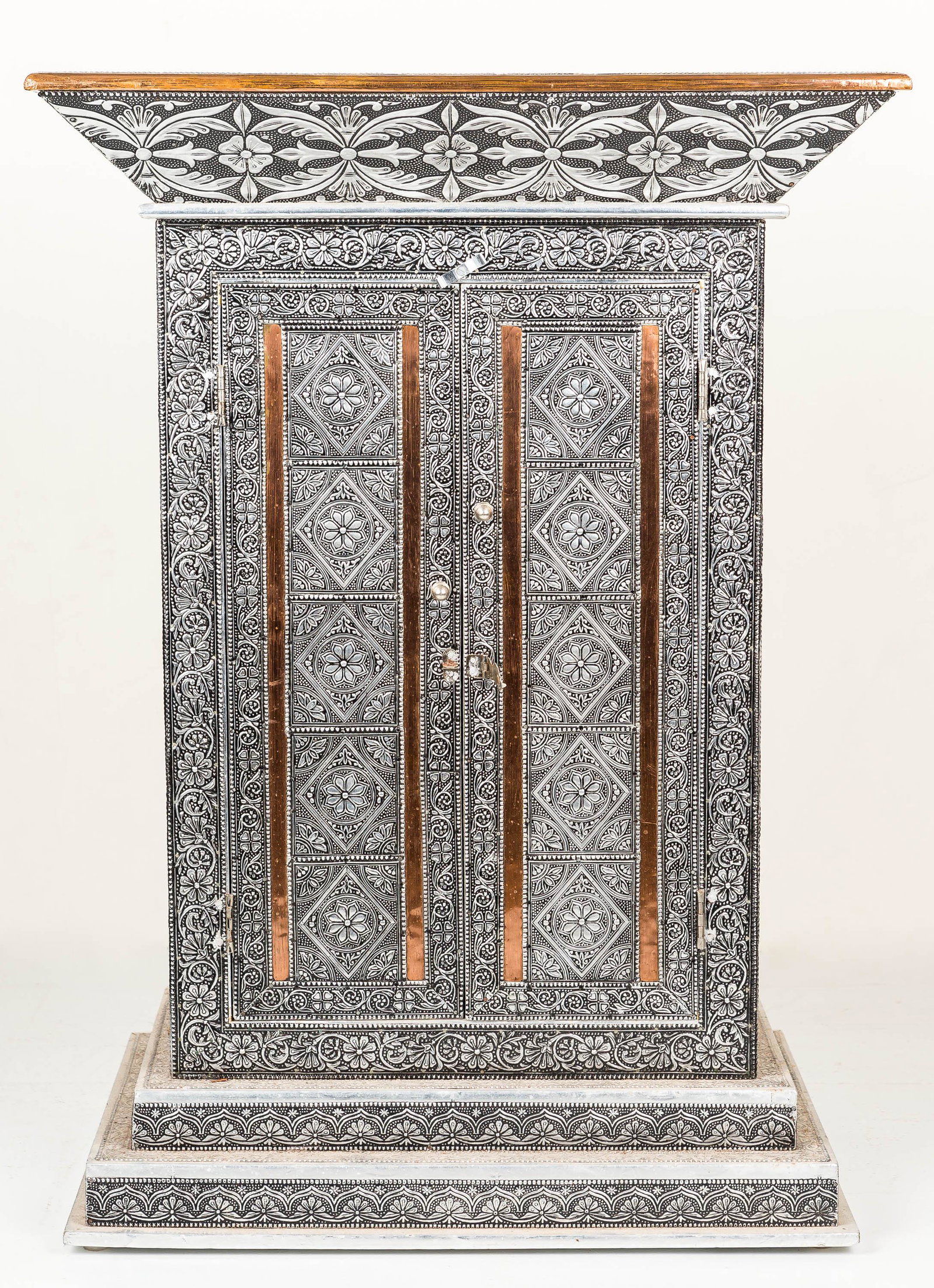 Middle Eastern Tin and Brass Table: Tin and brass decorated wooden cabinet. It measures approx 29 1/8"H x 21"W x 14"D.