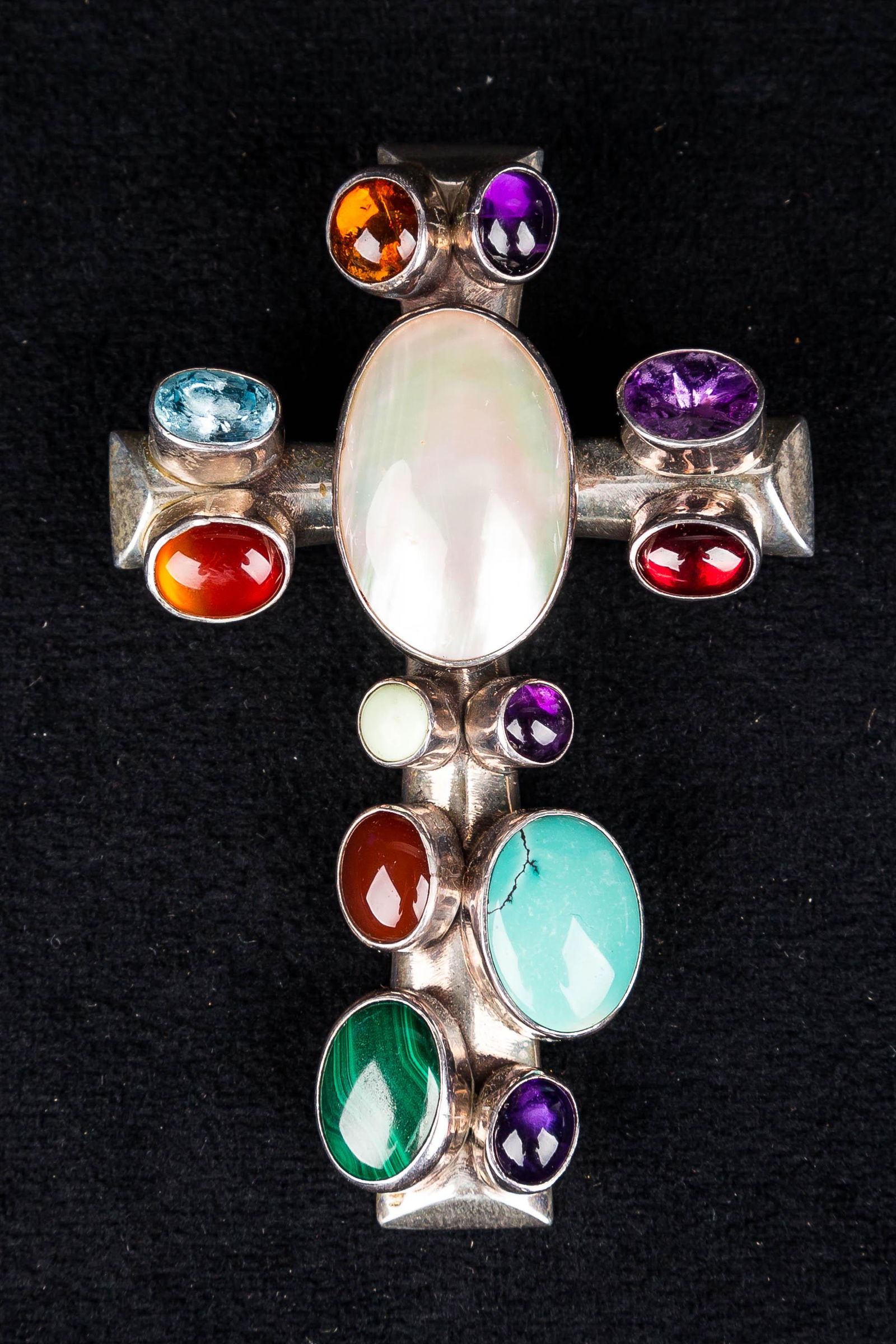 Heavy Sterling Jeweled Cross: This heavy, ornate sterling silver cross pendant, marked 'sterling', and signed. The cross is set with large amethyst, turquoise, amber, carnelian, malachite, topaz, and mother of pearl insets. Pendan