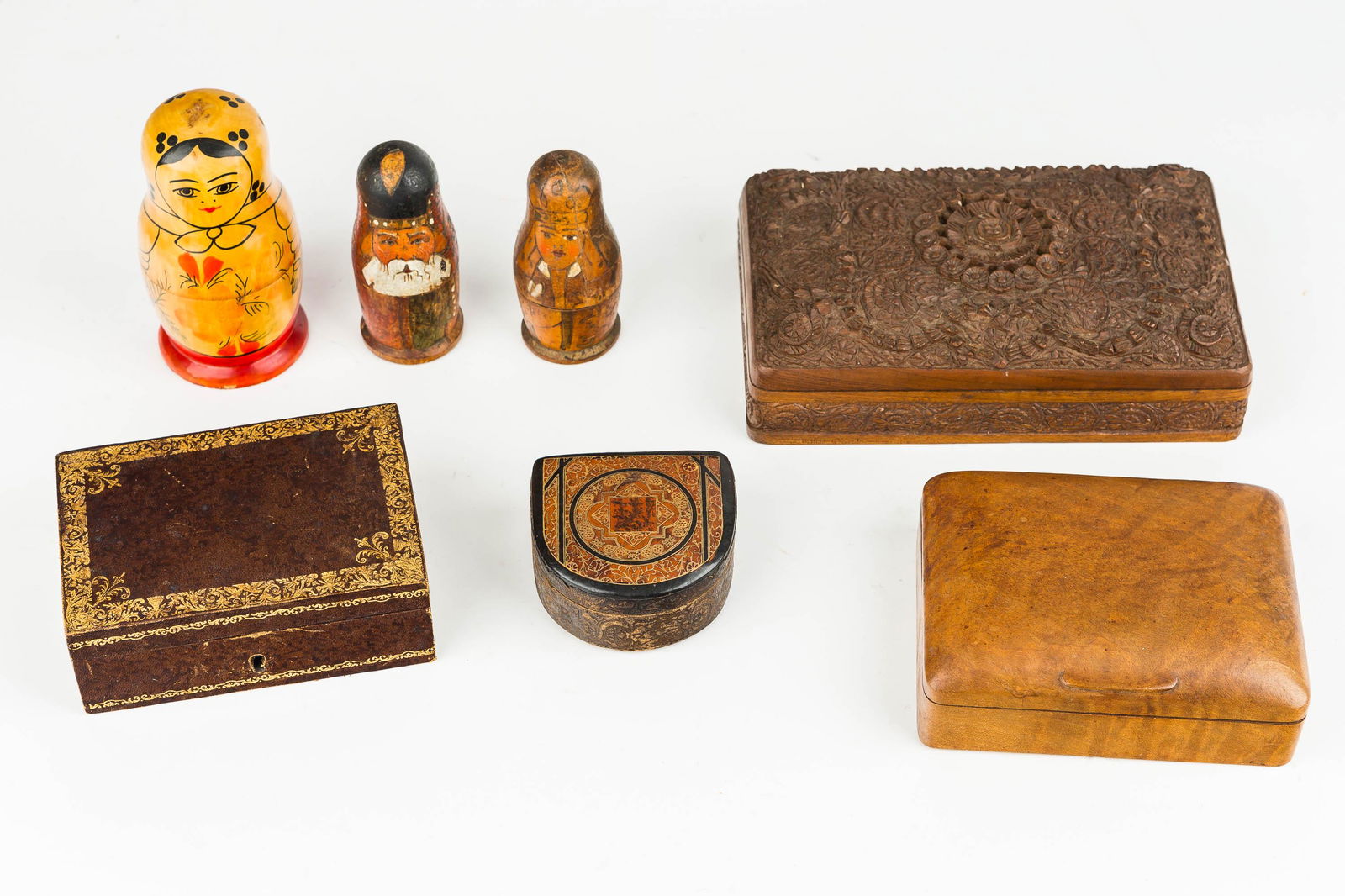 Wood Boxes and Nesting Dolls: One carved wood top, one plain wood and two covered leather boxes. Also includes three Russian nesting dolls.