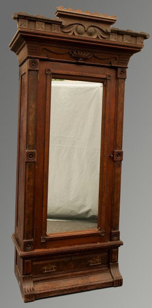 Victorian Armoire: with carved crest over a single door with mirror flanked by reeded pilars over a base with drawer, 87"x44"x22"d