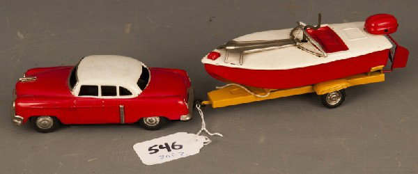 Japan Tin Toy: Japanese tin friction car, boat, and trailer set ca. 1950