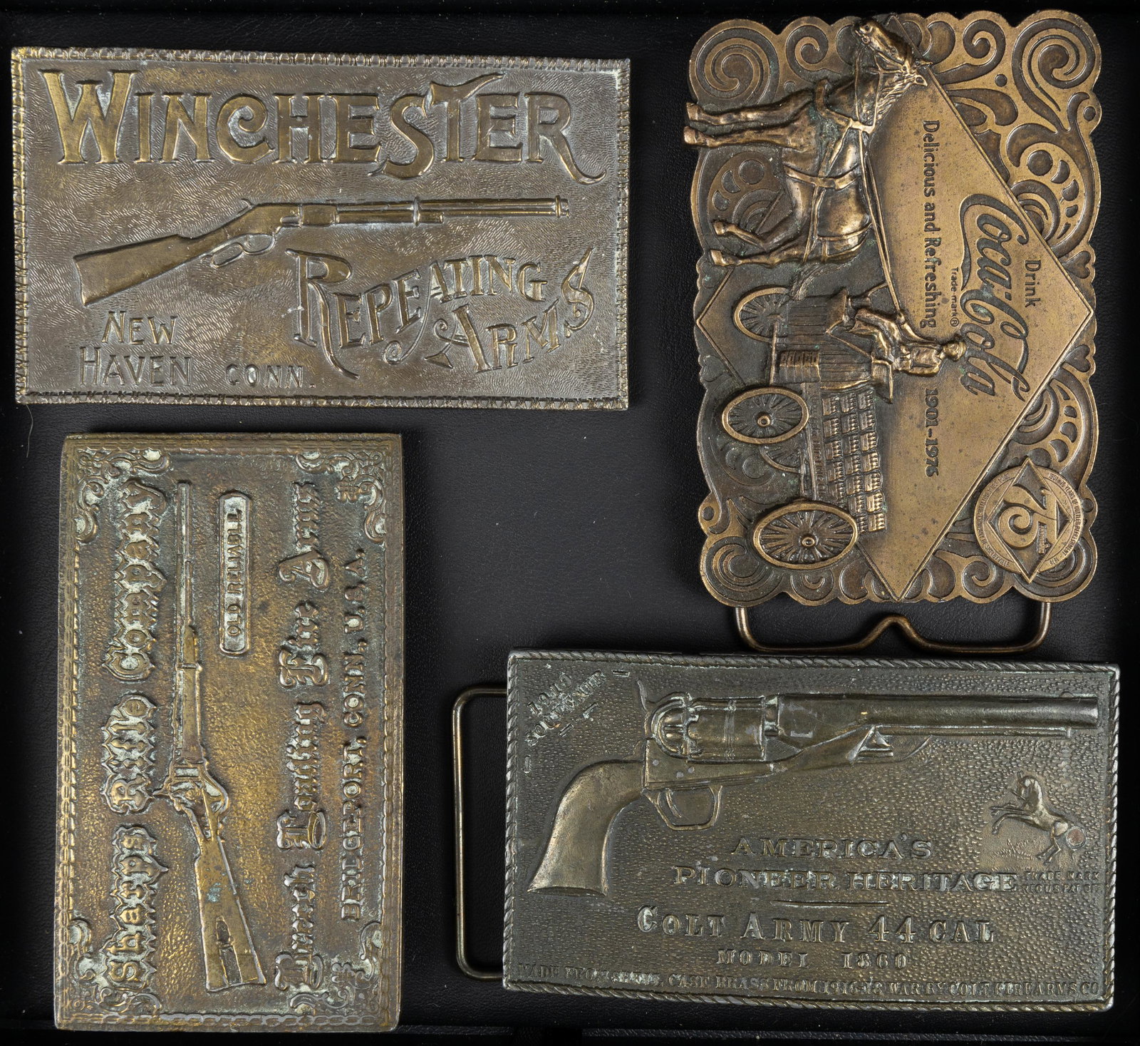 Brass Belt Buckles (4): There are four belt buckles including a 1919 Colt buckle marked Tiffany Studio on back, a Winchester buckle marked Lewis Buckles Chicago, a Sharps Rifle Company buckle, and a 1976 Coca-Cola buckle 75t