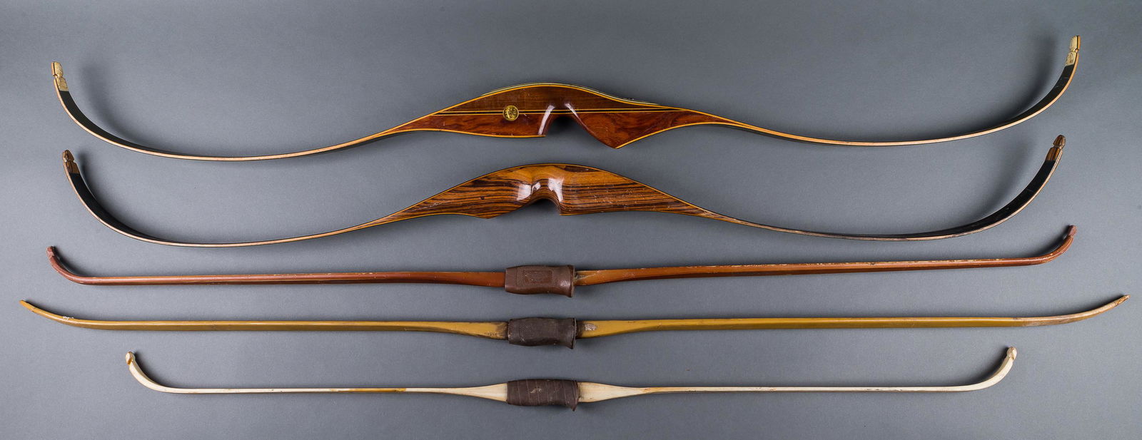 Vintage Fred Bear, Ben Pearson & Other Bows: 3 fiberglass bows, 1 by Shakespeare approx 56"L, 1 by Ben Pearson approx 47"L, and unmarked approx 60"L, 1 Fred Bear recurve 'Glass Powered Kodiak Hunter' laminated wood with fiberglass approx 55.5"L,