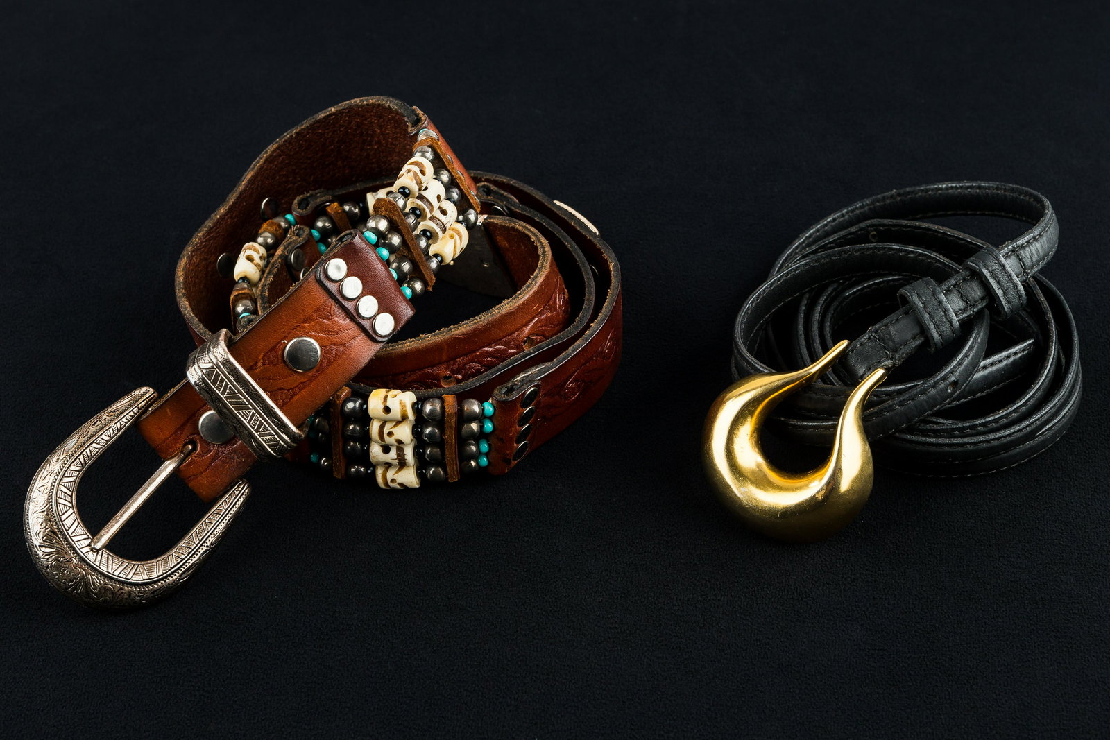 Robert Lee Morris Belt: Robert Lee Morris gold tone belt buckle and black leather belt size M, and Native American style skull bead leather belt approx 46.5"L.