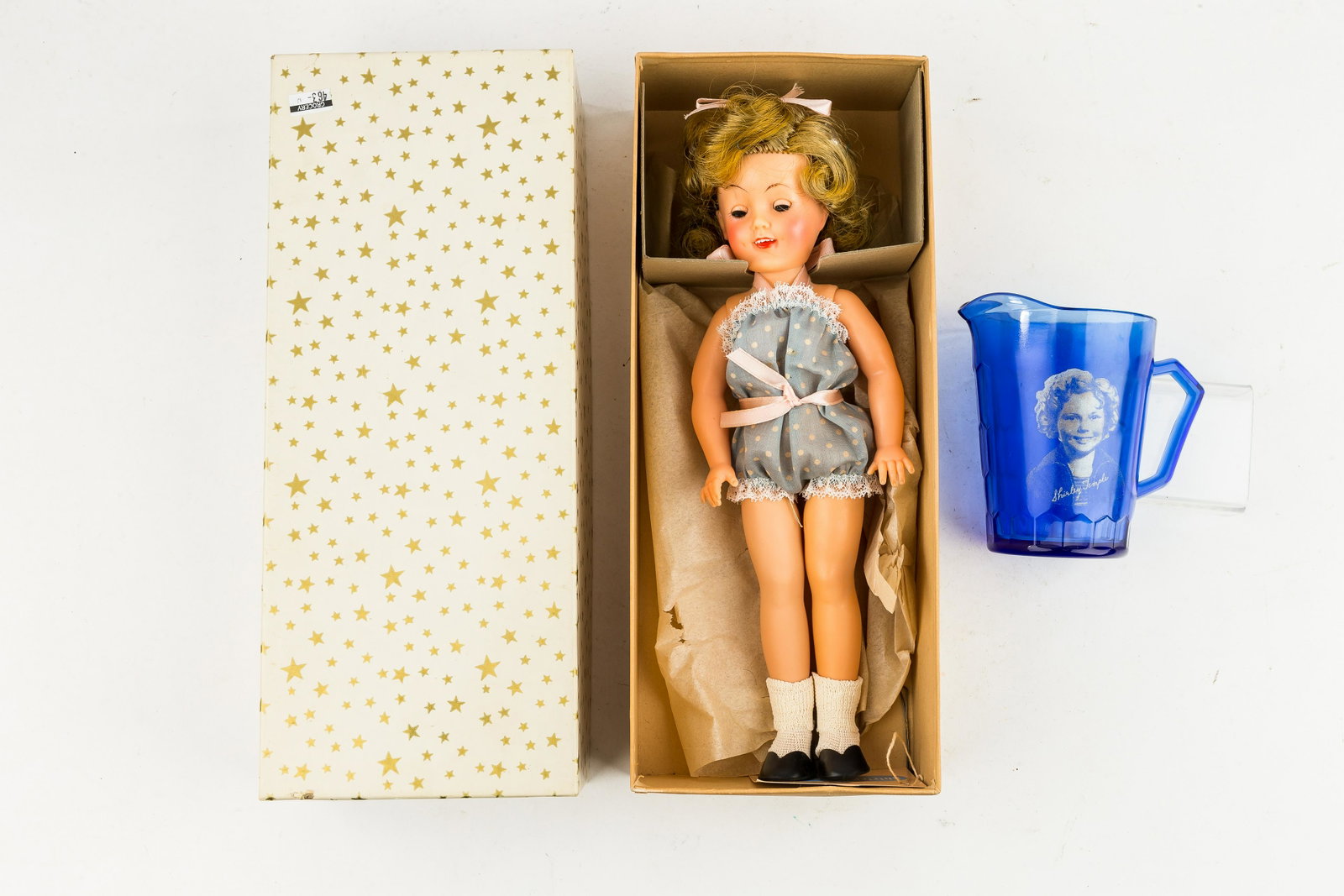 Shirley Temple Ideal Toy Co. Doll & Pitcher: This MIB Shirley Temple doll by the Ideal Toy Corporation has working sleepy eyes, open mouth, upper teeth, still in place hair net and bobby pins all in original box, marked on neck 'Ideal Doll ST-12