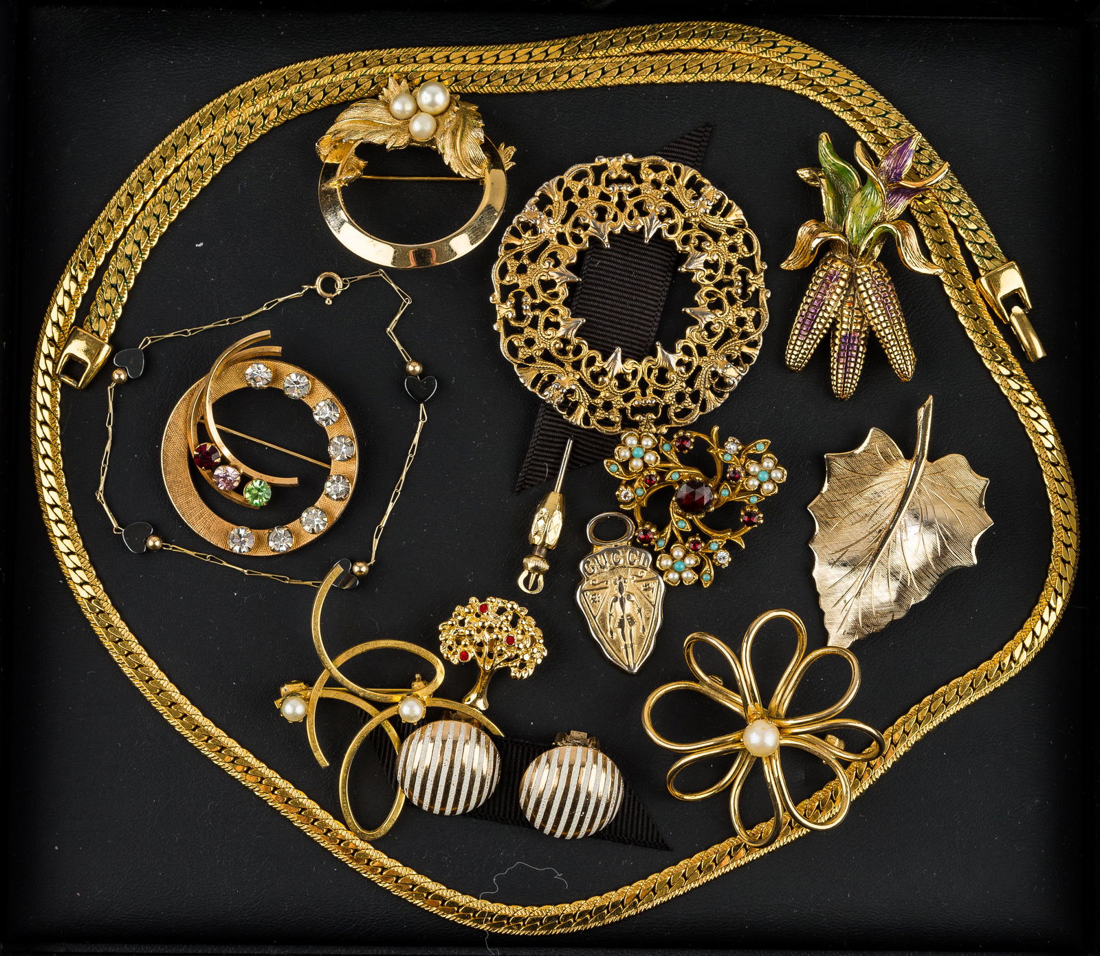Gold Filled/Gold Tone Vintage & Costume Jewelry: Beautiful collection of jewelry featuring a 30" Napier necklace, a vintage filigree stick pin, a delicate bracelet 1/20 12K.G.F with pronged rhinestones, a Gucci zipper pull, a Sarah Coventry 3 faux p