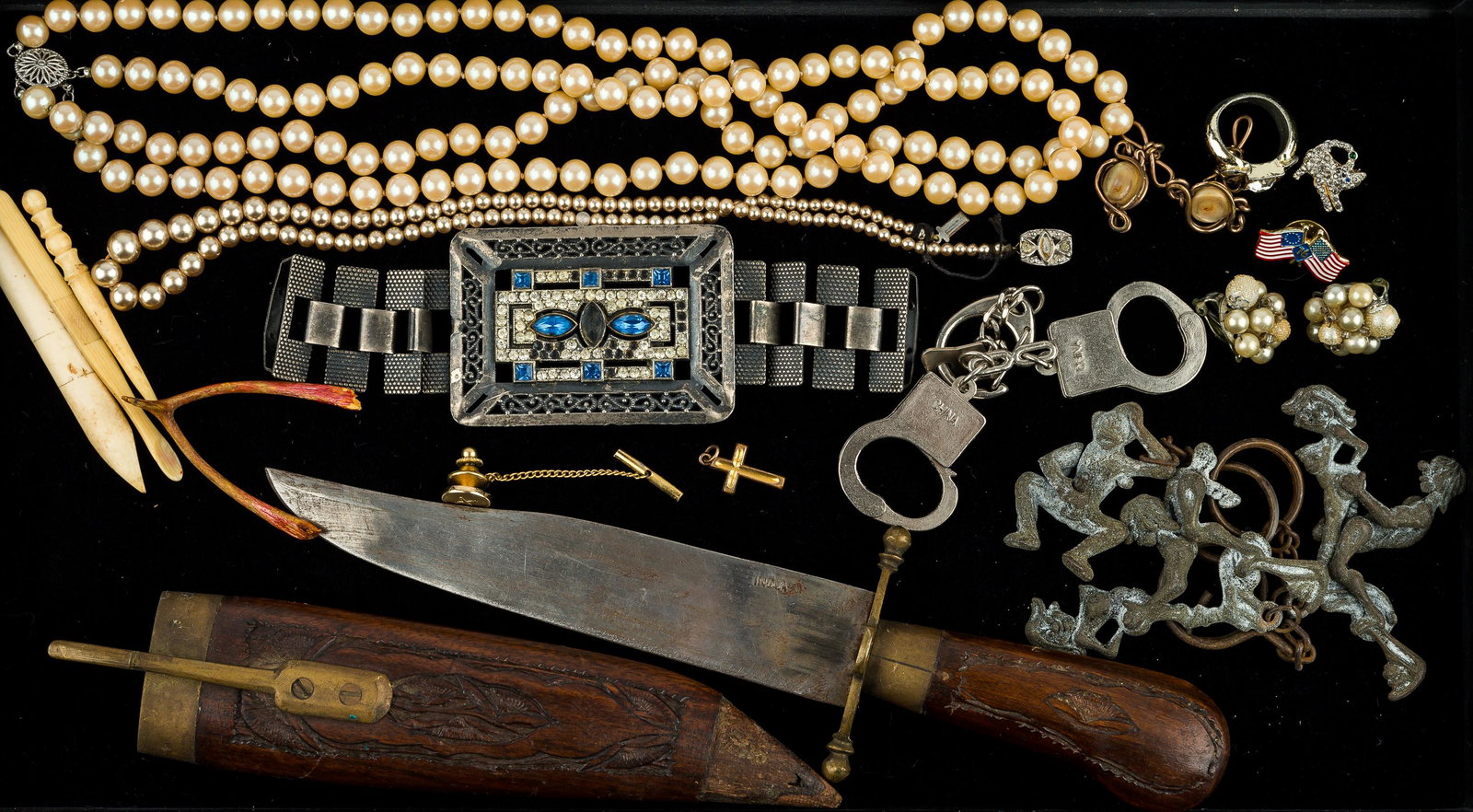Costume Jewelry, Gag Items and More: Faux pearls with sterling clasps, knife in locking wood sheath, erotic metal key chain figures, thumb handcuffs with key, antique mother of pearl and gold plated wire cufflinks, and more.