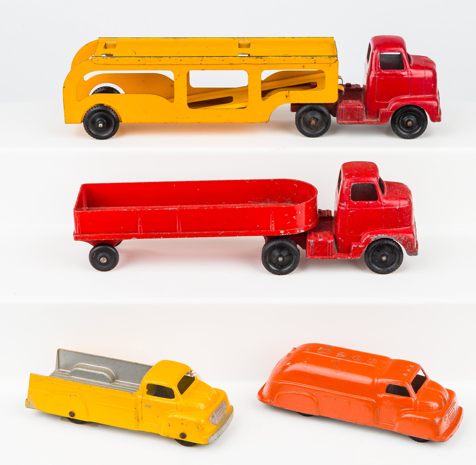 Vintage Tootsie Toy Trucks: 4 Vintage Tootsie Toy trucks including car hauler in very good condition, grain hauler in good condition, flat bed in very good condition, and tanker in good condition, conditions as seen in photos.