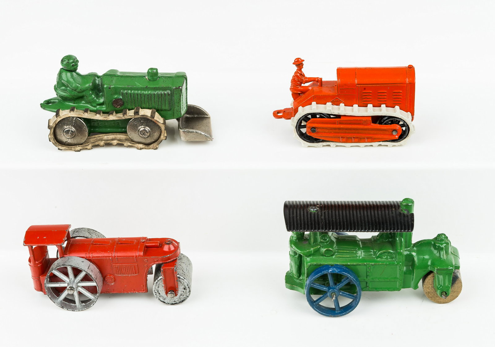 Antique Tootsie Toy & Hubley Toy Trucks, Tractors: Hubley fire ladder truck approx 5"L in very good condition, Hubley bulldozer in very good condition, Hubley steam roller in very good condition, and Tootsie Toy steam roller in very good condition, co