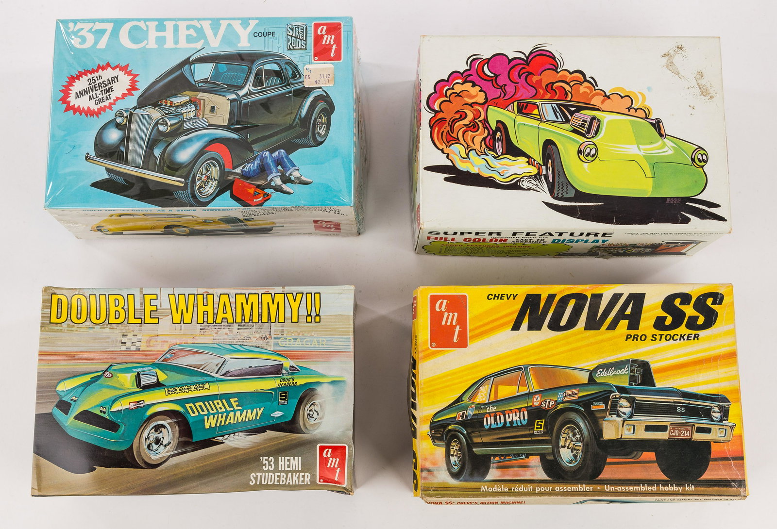 Vintage AMT Scale Models (4): Vintage AMT scale model kits in original boxes included 37' Chevy coupe 1/25 scale, box in excellent condition, all parts intact/included, Double Whammy Hemi Studabaker 1/25 scale, box in good conditi