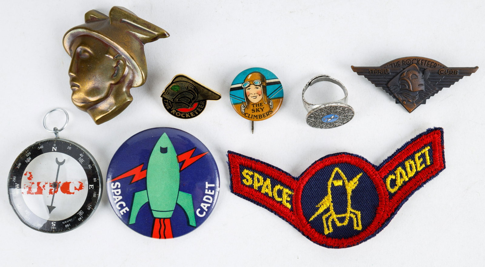 Premium Pinbacks and Patches, Space Related: Vintage Sky Climbers Ralston pinback, Space Cadet patch and pinback, Oui Men's Magazine decorder ring and compass, Mercury styled belt buckle, The Rocketeer Thrill Club c1990 wings pin and related pin
