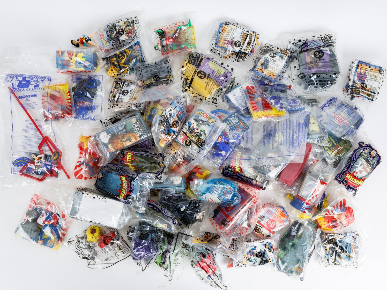 Fast Food Premiums in Bags (~55): Superman, various DC Comic characters, Universal Studios Monsters, Batman, and more. Approx 55. A few bags are open.