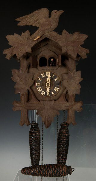 Heco Cuckoo Clock: hero 8 day cuckoo clock with pendulum and 3 weights, crest, (missing a character in one of the doors) 9 1/2"h x 7"w
