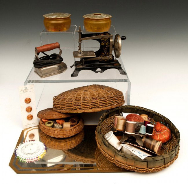 Sewing Lot: Sewing lot including two sewing baskets, german minature sewing machine, iron, Bakeaute boxes, and mirror