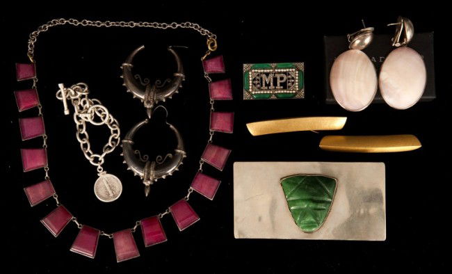 Silver Jewelry: Grouping of silver jewelry. Including a large belt buckle with carved jade face (marked Mexico), sterling silver shell earrings, US 1940 dime coin bracelet, rings, ruby necklace, etc.