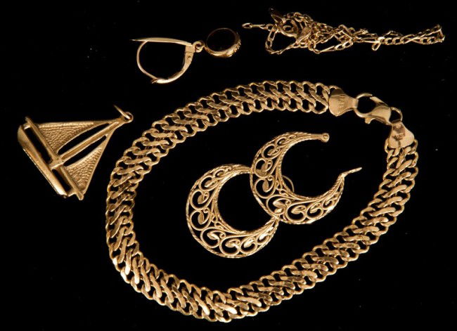 14k Gold Lot: Grouping of gold. All 14K yellow gold including sail boat charm, two bracelets, earrings, 6.8dwt.