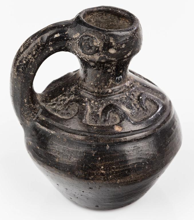 Andean / Moche Chimu Bird Vessel: This black pottery Chimu Bird vessel approx 4" H x 3.5" diameter attributed to the Chimu people of coastal Peru and made in the form of a bird's head at the spout and a handle. Around the main part of