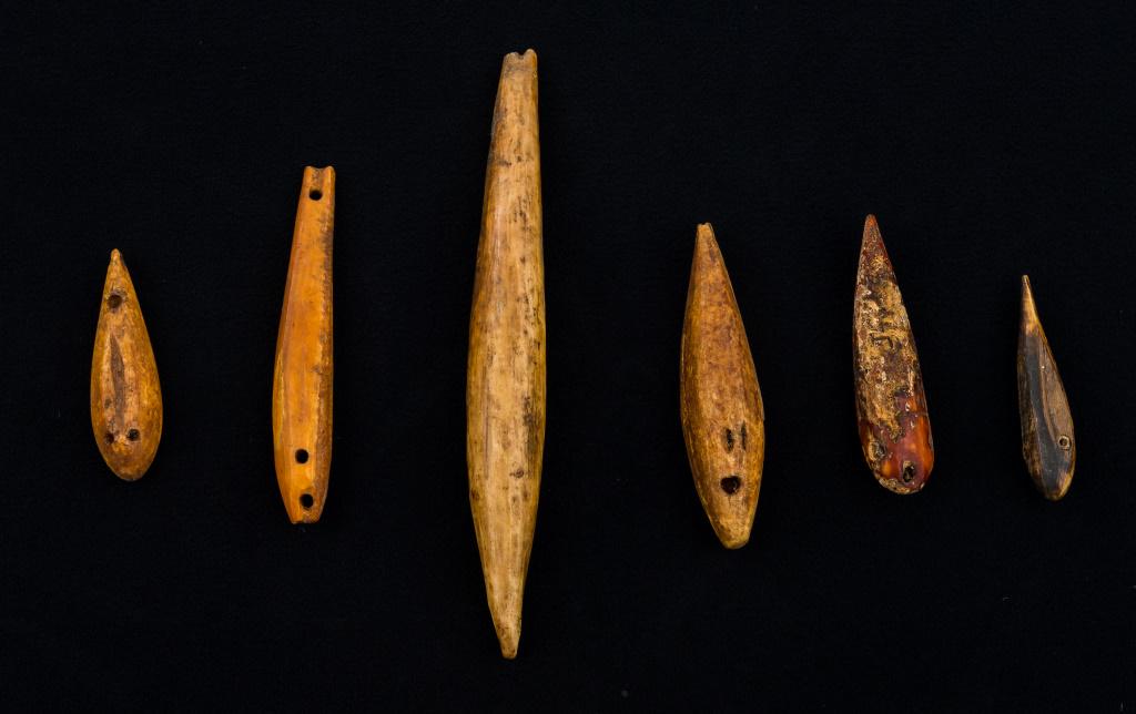 Inuit Eskimo Fishing Lures: 6 Inuit Eskimo fishing lures made from fossilized bone, many with eye detail, largest approx 6"L, from Savoonga mainland Inupiak Thule.