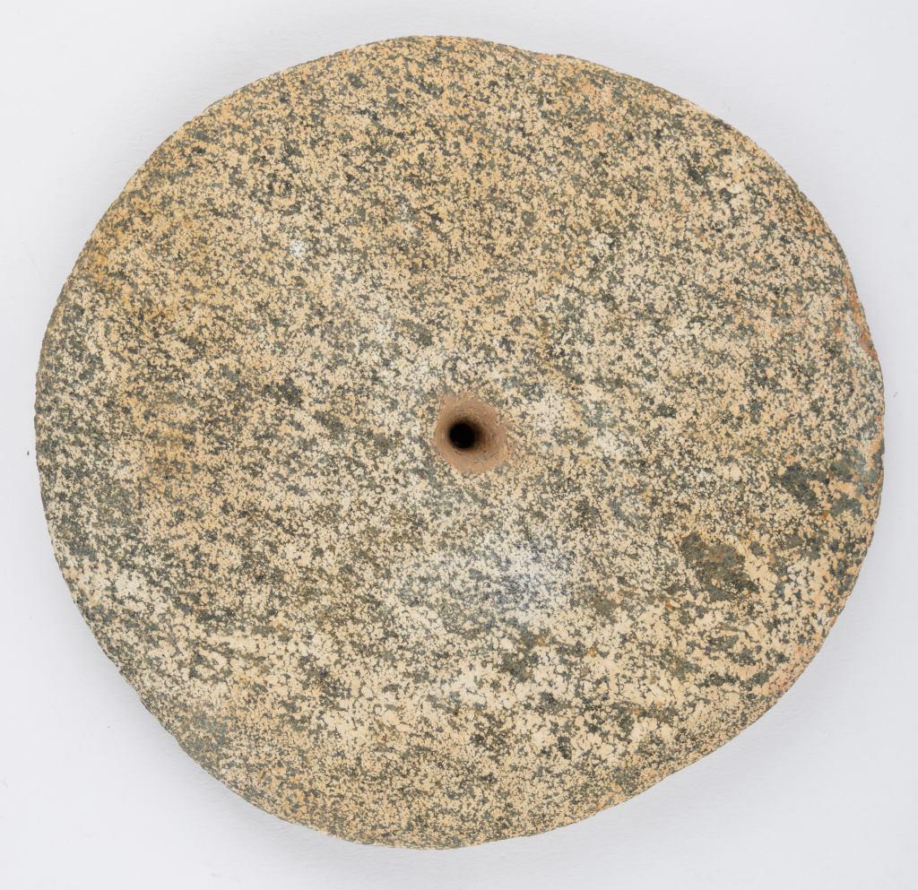 Neolithic Sahara Granite Disk: Large Neolithic Sahara granite disk found in Mauritania, approx 5.25" diam, with biconical drilled hole in center, with some ancient wear on edges.