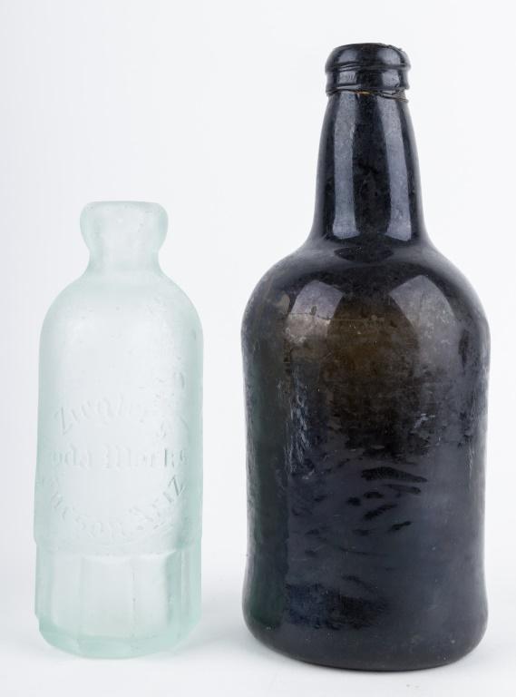 Antique Old Tucson Western Bottles (2): 2 Antique 'Old West' bottles, 1 hand blown dark black/green liquor bottle approx 9"H, and 1 aqua Hutchinson bottle 'Ziegler's Soda Works' Tucson Arizona approx 6.75"H from 'Old Tucson' area, has frost