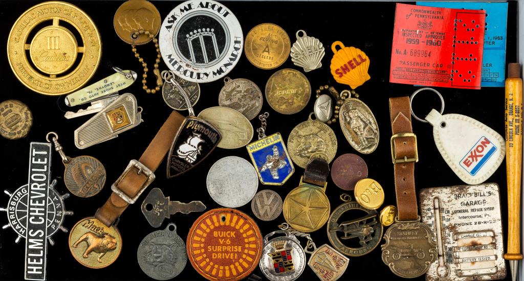 Vintage Fobs & Key Chain Collectibles: Approx 35+ pieces, mostly transportation themed, including Plymouth Chrysler emblem, Exxon key chain, Stanley and Mack fobs, and more.