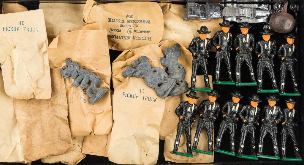 Vintage Cast Iron & Lead Toys: Approx 12+ Hudson brand lead vehicle kits in assorted variety, 11 cast iron painted cowboys, 1 cast iron clock weight, and 3 lead Disney figures including Mickey, Minnie Mouse, and Pluto.