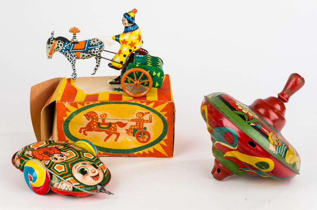 Vintage Tin Litho Toys: Ohio Art tin top, TPS Japan made ladybug/turtle flipping wind up, and unmarked clown with horse and cart with original unmarked box.