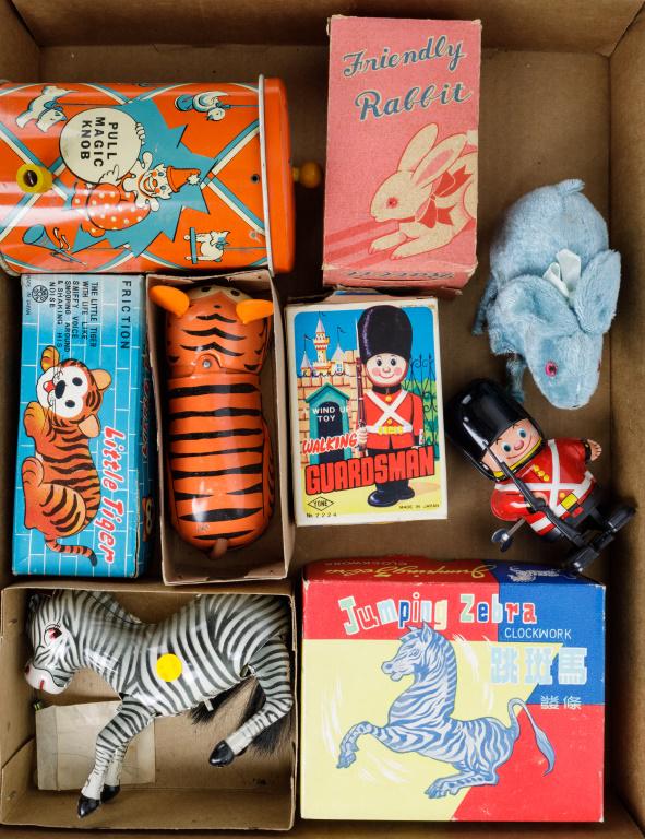 Tin Litho Wind Up Toys NIB: China made jumping zebra and 'Little Tiger', Tone brand walking guardsman, friendly rabbit, and pull knob magic clown in can.