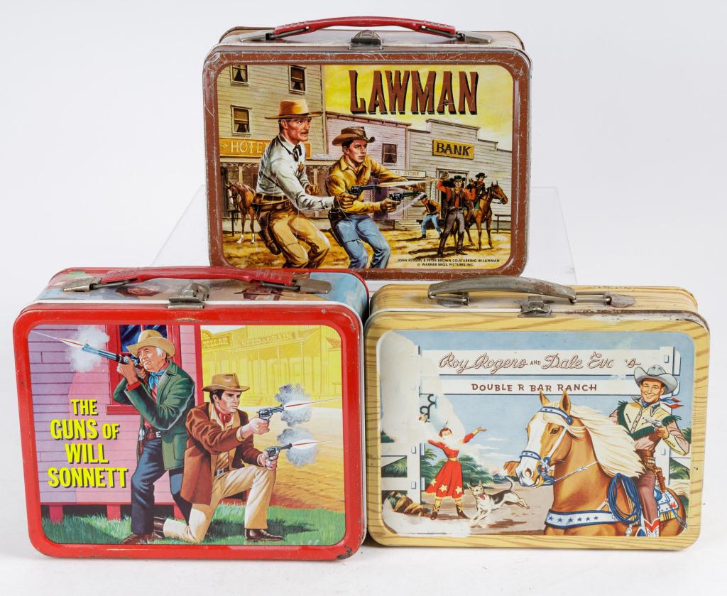 Vintage Western TV Show Metal Lunch Boxes: 3 Vintage metal lunch boxes, including Roy Rogers and Dale Evans Double R Bar Ranch, The Guns of Will Sonnet, and Lawman, wear commensurate with age and use.