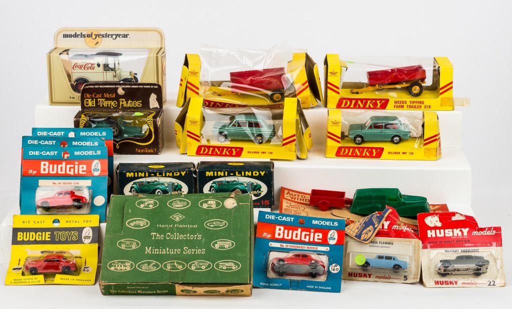 Vintage Die Cast Toys: Husky cars NIP, 5 Budgie toys NIP, 1 Coca Cola Matchbox NIB, Product of Universal 'Old Time Auto' NIB, 2 Mini-Lindy sports car models (1 assembled, 1 not), 4 Dinky's (2 farm trailers, 2 Hillman Imps),