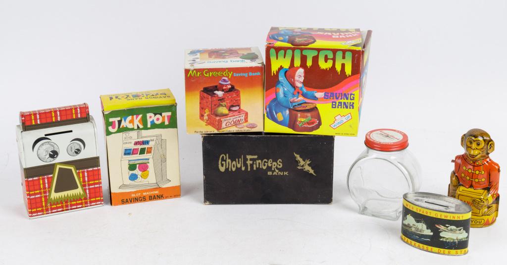 Vintage Toy Banks: West Berlin tin litho, monkey tin litho (missing arms), glass clock 'Kiddy Bank', Ohio Art tin litho 'Mr. Thrifty' NIB, tin litho 'Jack Pot' slot machine bank NIB, BO Ghoul Fingers bank in original bo